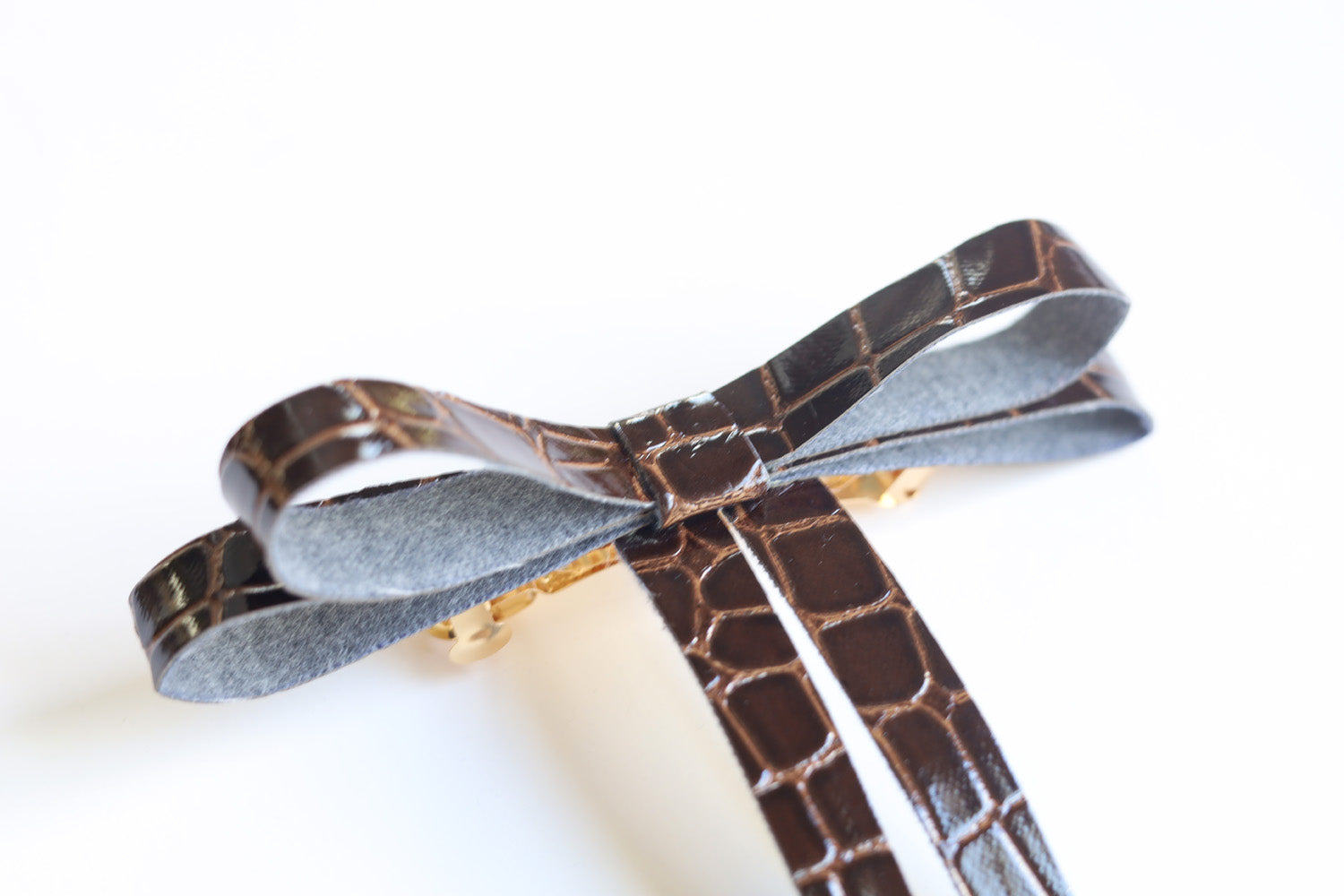 Boucle en similicuir sur barrette dorée